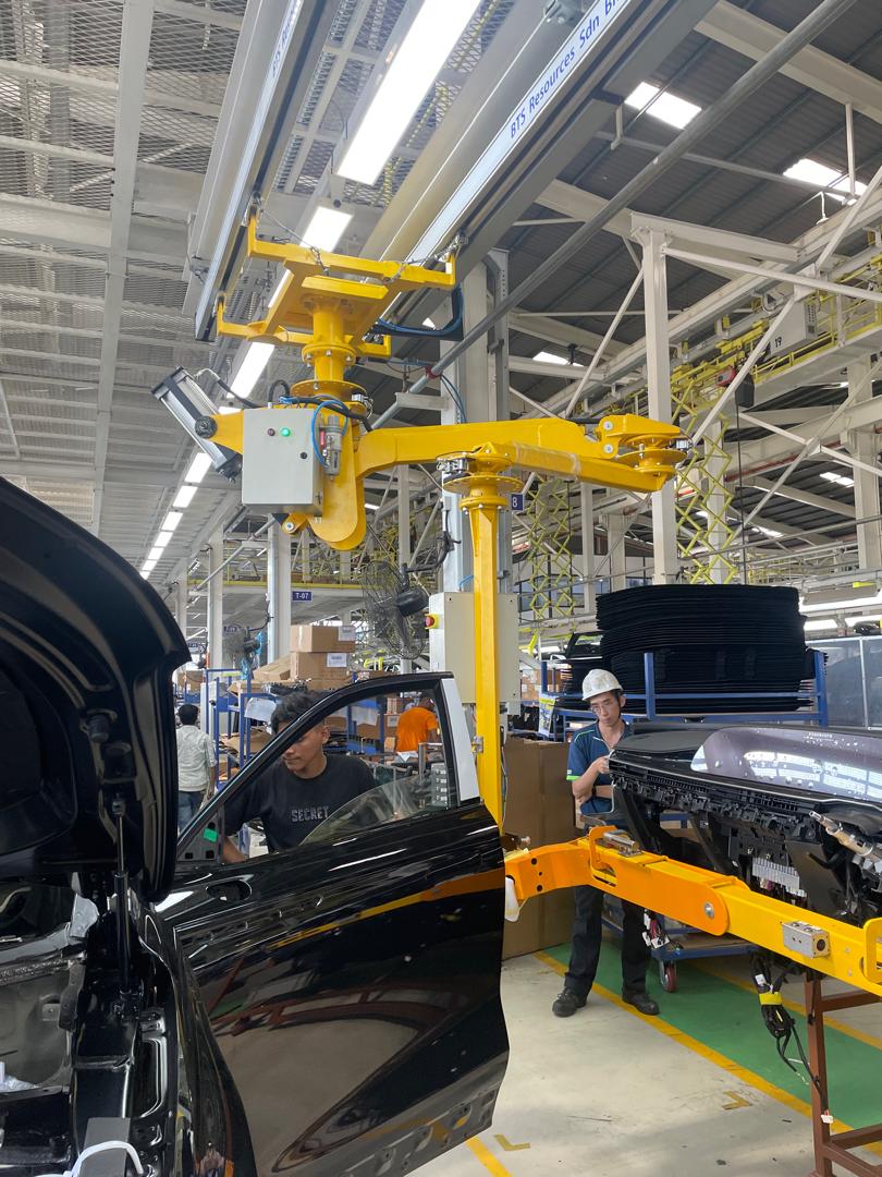 Ovity air manipulator handling a car door on an EV assembly line in Malaysia